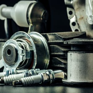 Close up of set of new car parts on black background