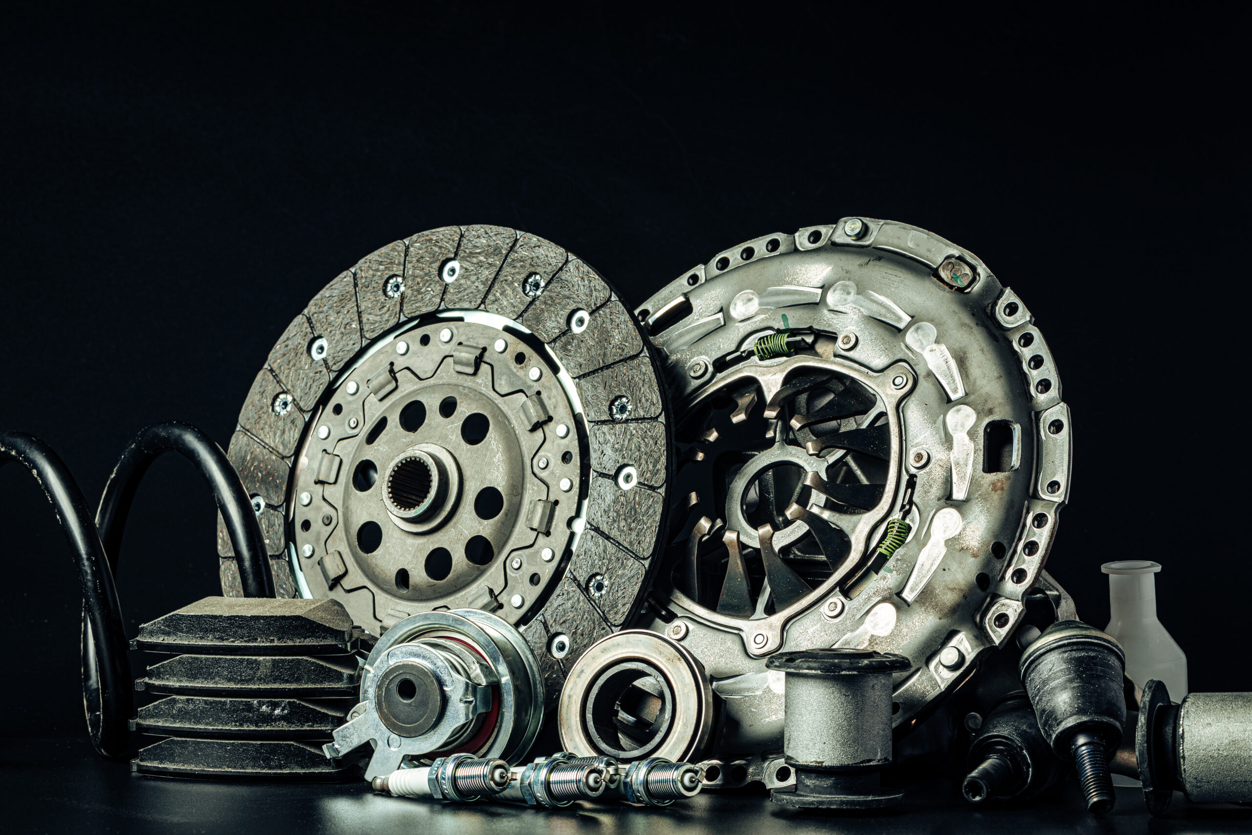 Close up of set of new car parts on black background